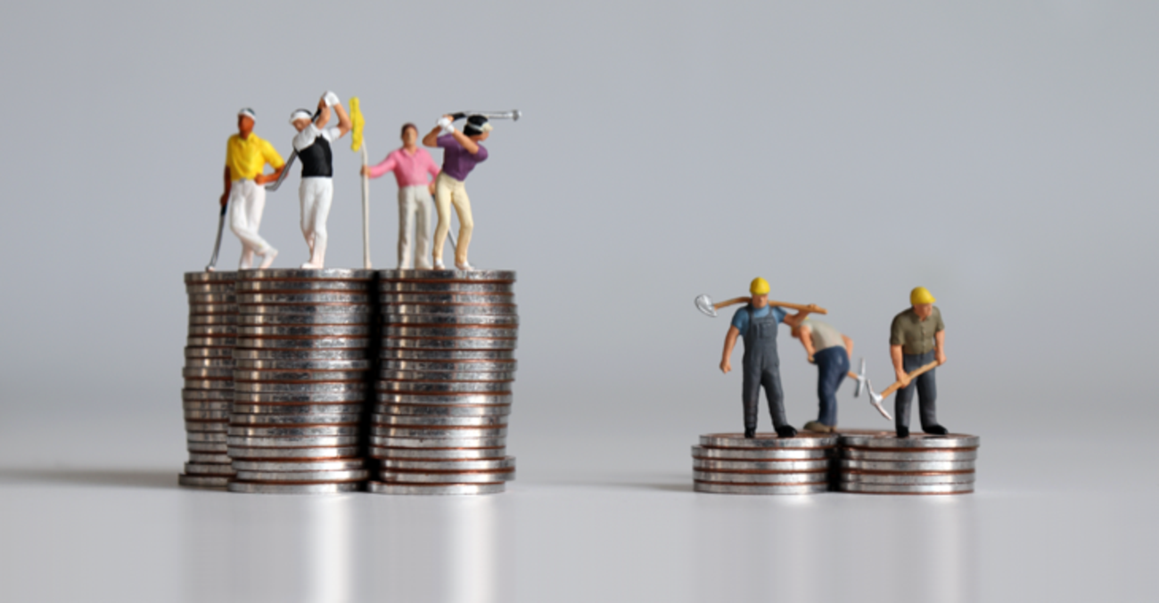 Golfspieler-Miniaturfiguren auf einem hohen Münzhaufen und Arbeiter-Miniaturfiguren auf einem flachen Münzhaufen © iStock