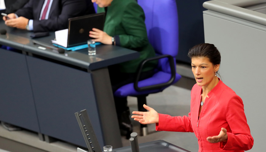 Sahra Wagenknecht am Rednerpult des Bundestages, dahinter Kanzlerin Merkel auf der Reigerungsbank © dpa Sahra Wagenknecht am Rednerpult des Bundestages, dahinter Kanzlerin Merkel auf der Reigerungsbank © dpa