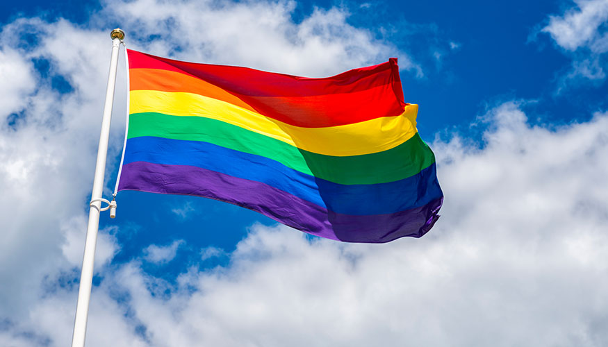 Regenbogenfahne vor blauem Himmel © istockphoto.com / Martin Wahlborg Regenbogenfahne vor blauem Himmel